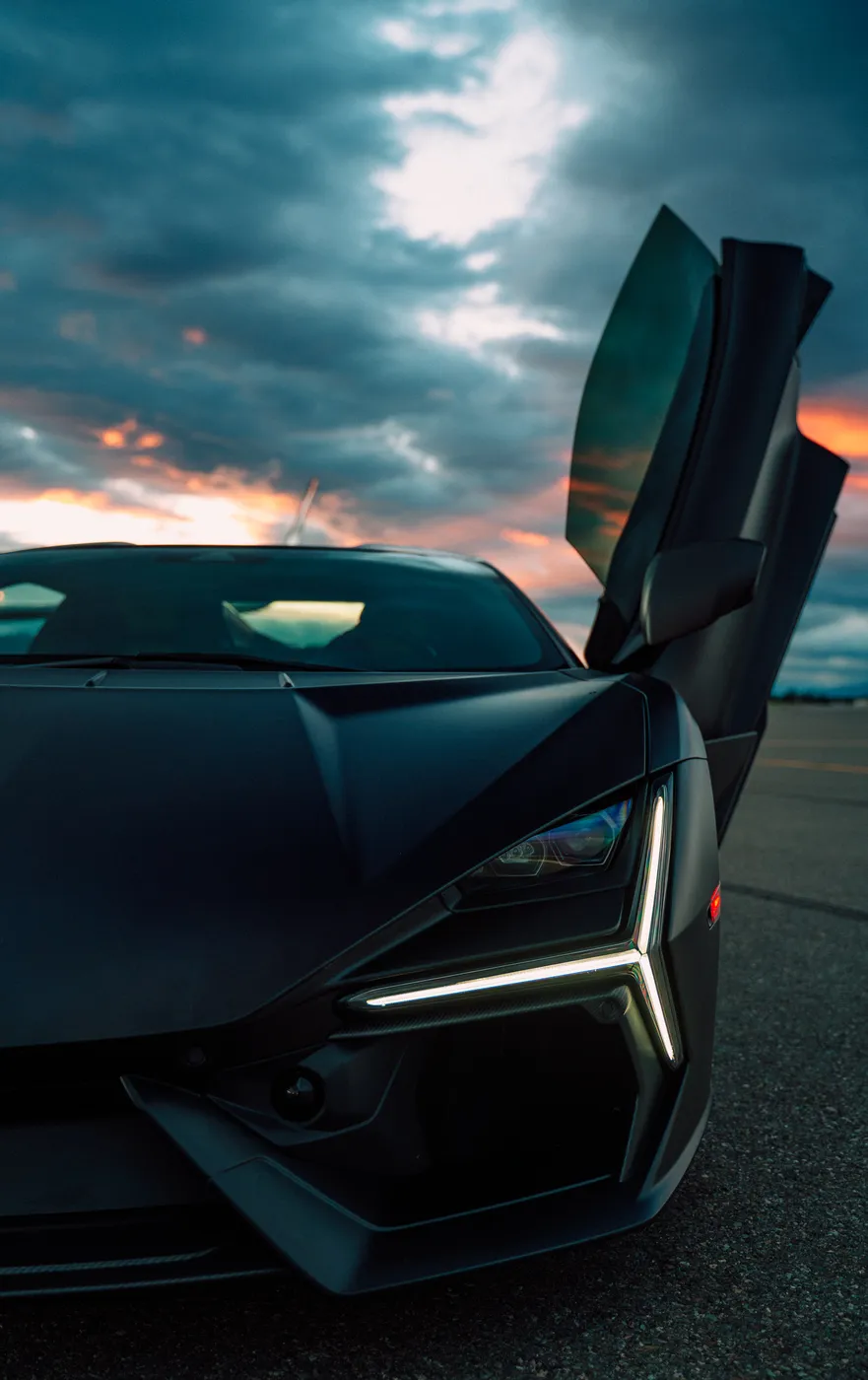 Front three-quarter of the Revuelto at dusk with its signature running lights lit
